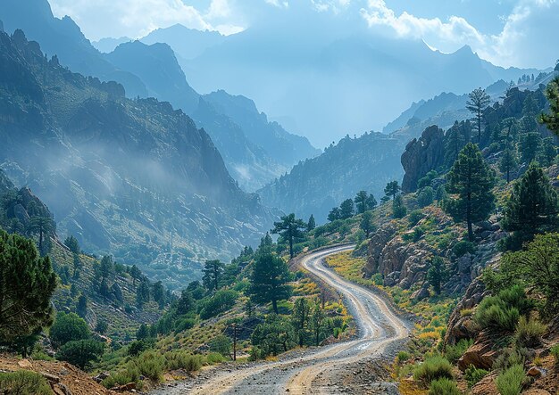 a winding road in the mountains with a road in the background
