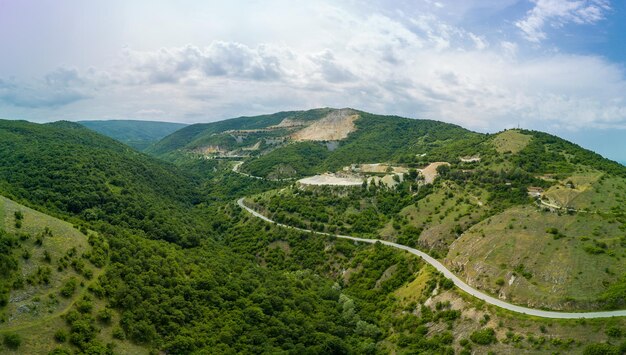 Winding track is like slopes of rhodope mountains with forests panorama top view