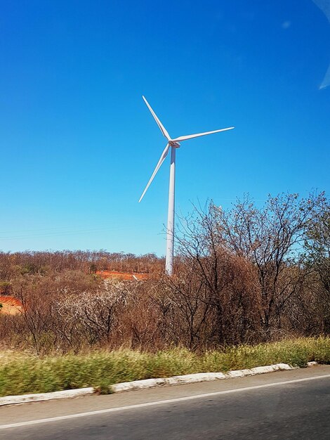 Windmill against clear blue sky