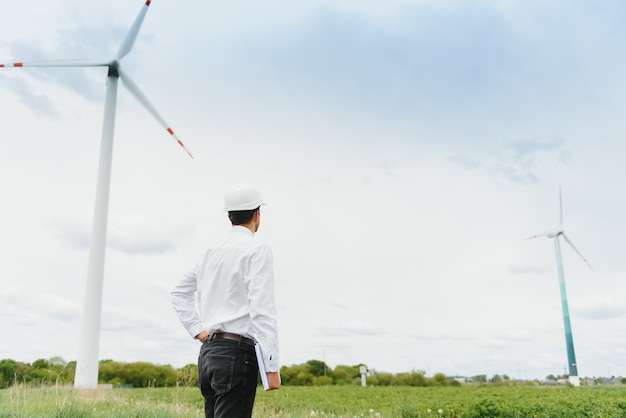 Windmill engineer inspection and progress check wind turbine at construction site.