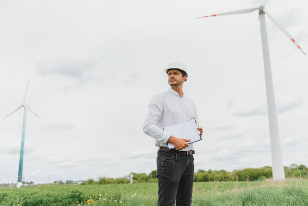 Windmill engineer inspection and progress check wind turbine at construction site.