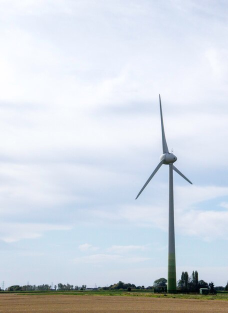 Windmill on field against sky