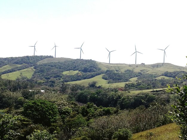 Windmill on field against sky