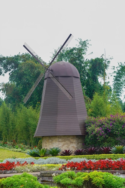 windmill in flowers garden park premium photo