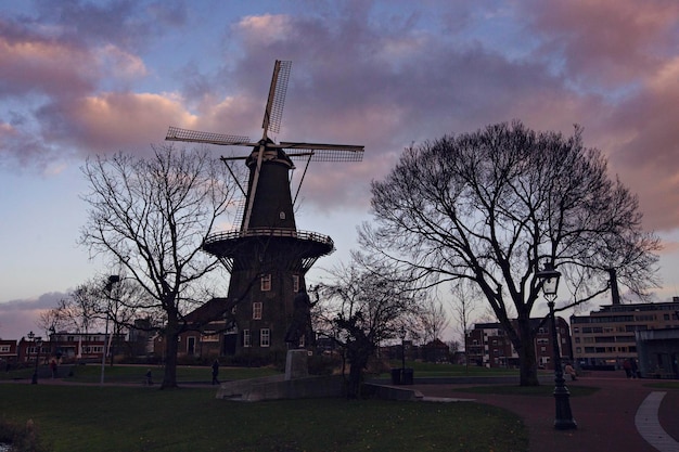 A windmill in the netherlands with a cloudy sky