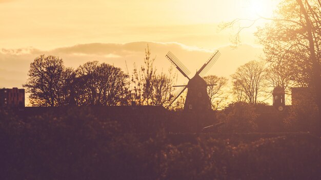 Windmill silhouette panoramic view at sunset