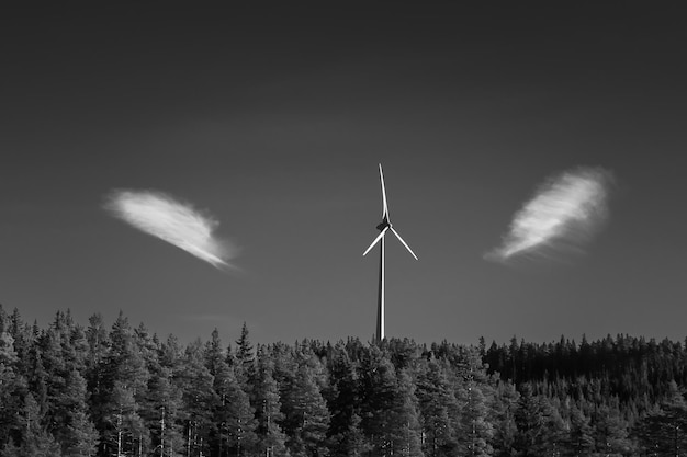 Windmill and trees against sky