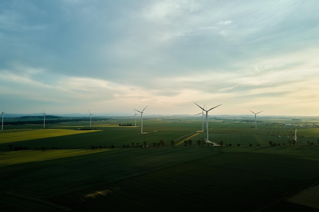 Windmill turbines at sunset Wind energy concept