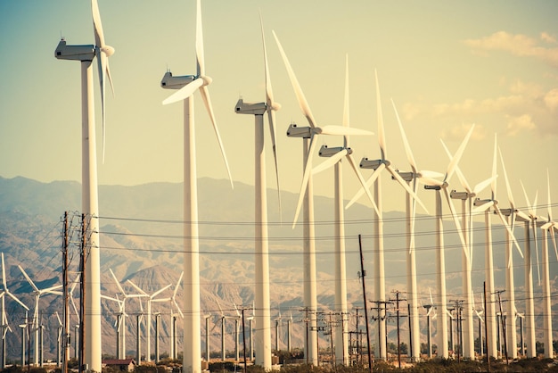 windmills against mountains during sunset