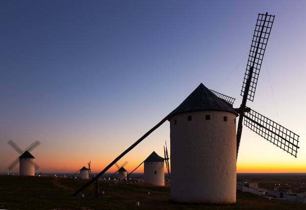 windmills at field in dusk