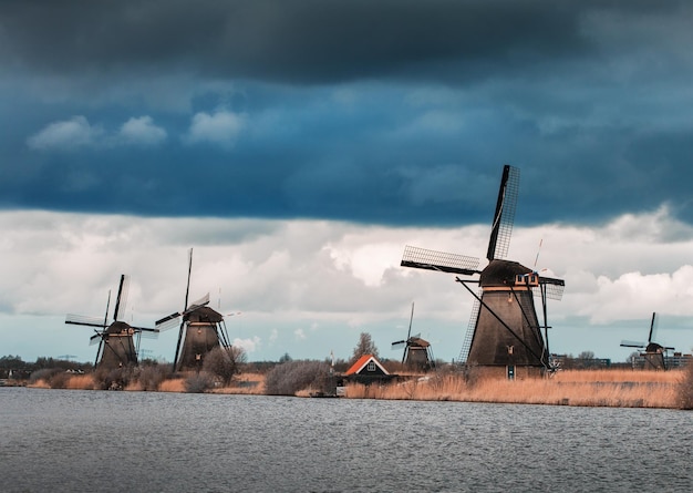 Windmolens tegen bewolkte hemel bij zonsondergang in Kinderdijk Nederland