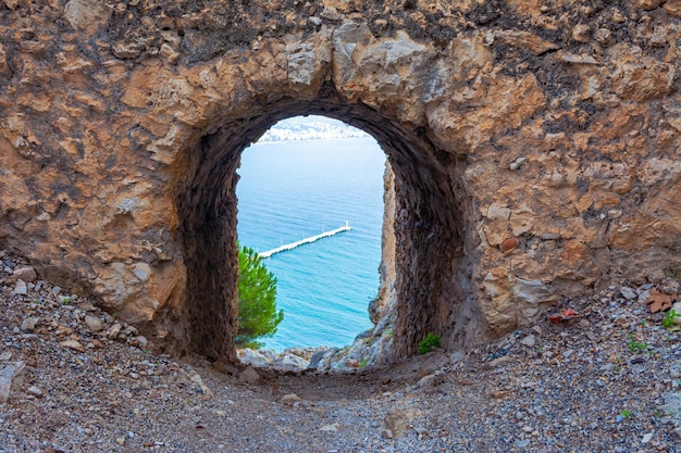 A window in an ancient building overlooking the sea