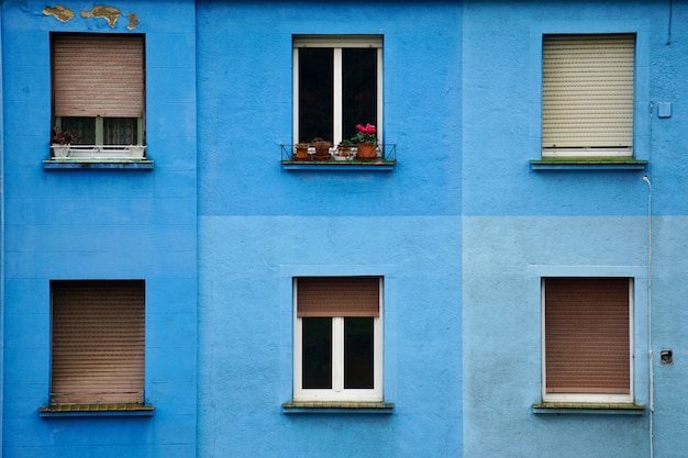      window on the blue building facade in the street in Bilbao city Spain