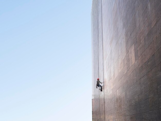 Window cleaner is working on the office building