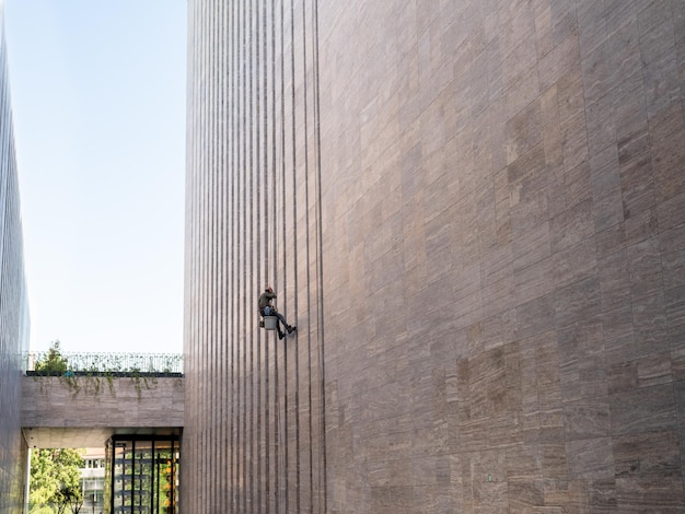 Window cleaner is working on the office building