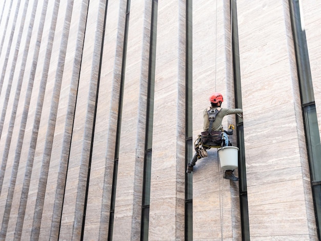 Window cleaner is working on the office building