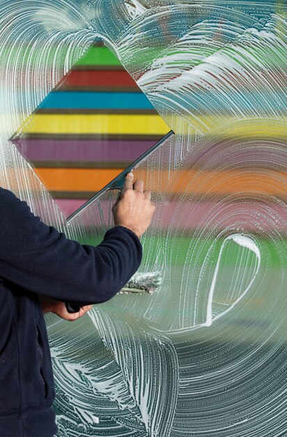 Photo window cleaner using a squeegee to wash a window