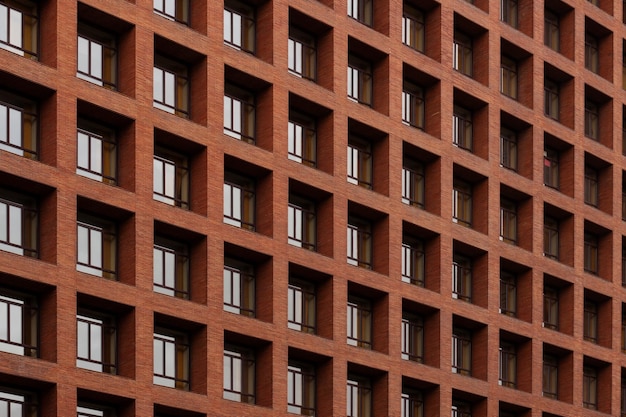 Window facade pattern with red brick walls