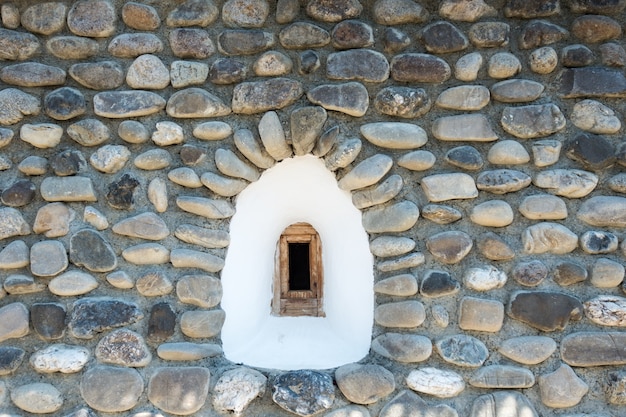 Window on the facade of a stone wall