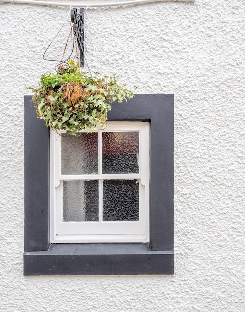 Photo window frame with glass and white rough wall for background