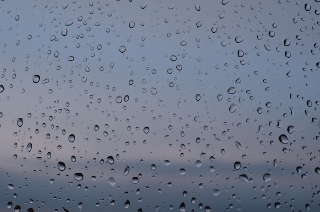 Window glass with water drops closeup Rainy weather