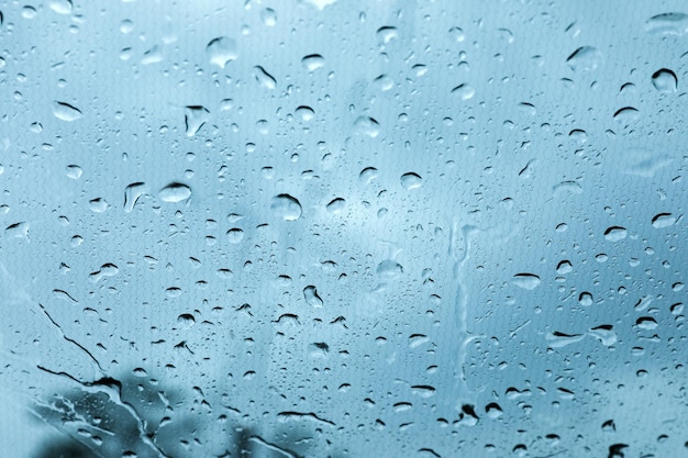 Window glass with water drops closeup view