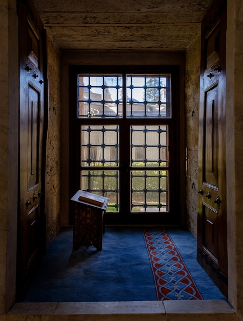 The window of a mosque and the quran in front of the window