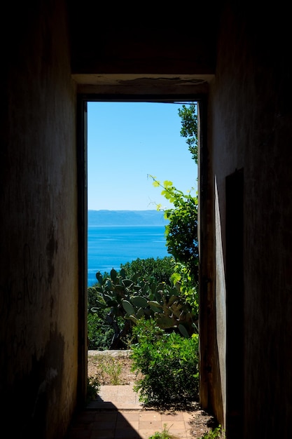 Window of an old abandoned building overlooking the sea