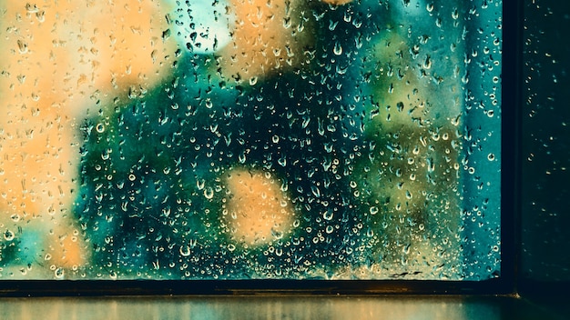 Window and rain drop in condominium or apartment room on a rainy day in Bangkok Thailand