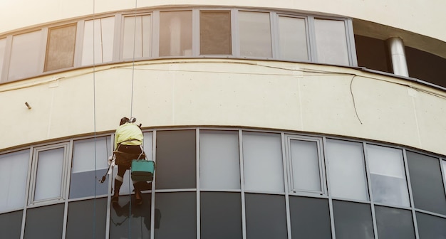 Window washer cleaning building facade