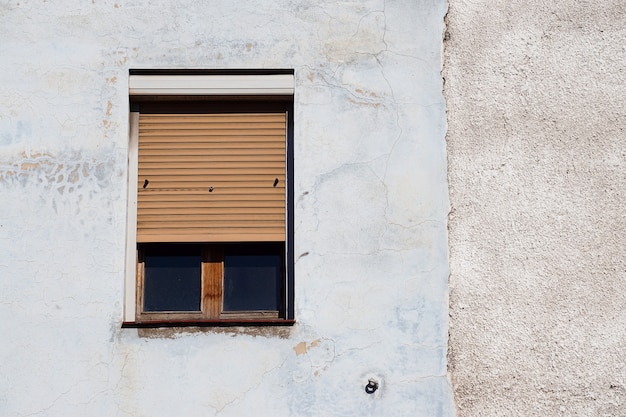 Window on the white building facade in Bilbao city Spain