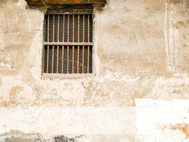 A window with bars on it that says