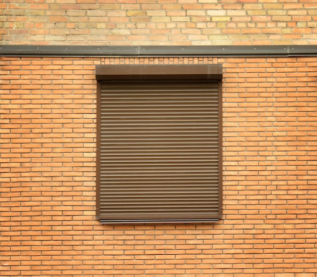 Window with closed roller blind in wall