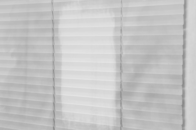 Window with dirty and clean blinds closeup