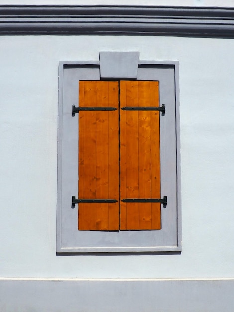 Photo window with old wooden shutters metal curly braces white wall country style petrovaradin novi sad se