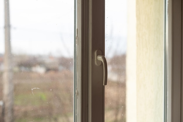 Window with very dirty and dusty glass in daylight