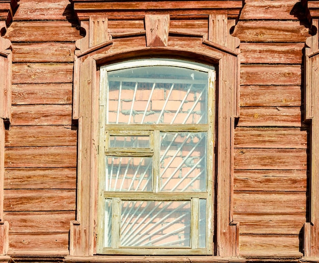 A window with a wooden frame and the word " sun " on it.