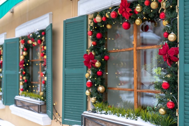 Windows are decorated with branches of fir and Christmas tinsel.