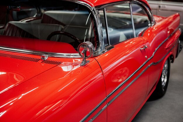 Windows, door and side of this red retro car are perfectly polished