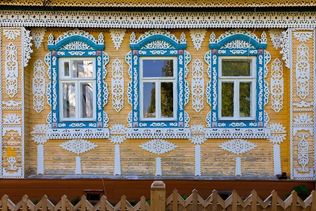 Windows of a wooden Russian village house with traditional carved wooden trim Plyos Russia