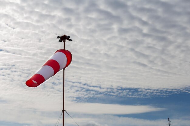 Windsock with cloudy sky in the background