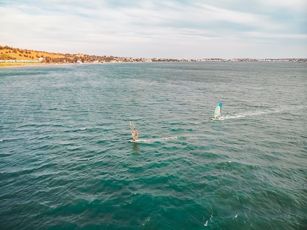 Windsurfer Surfen De wind op golven Recreatieve watersporten Extreme sport Actie Recreatieve sportactiviteit Gezonde actieve levensstijl Zomerplezier Avontuur Hobby