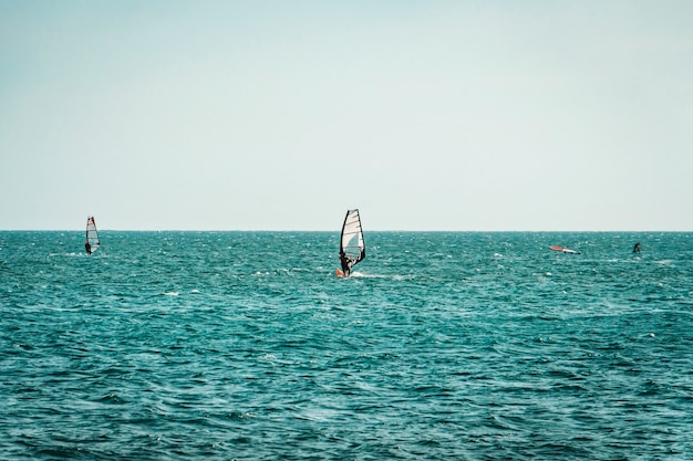 Windsurfer Surfing The Wind On Waves In Mui Ne, Vietnam. Recreational Water Sports, Extreme Sport Action. Recreational Sporting Activity. Healthy Active Lifestyle. Summer Fun Adventure. Hobby.