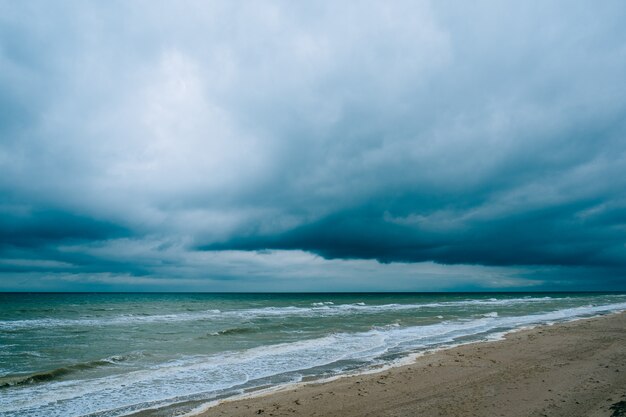 Windy storm beach sea waves with dark clouds