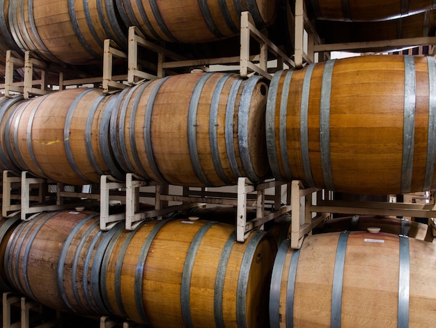 Wine barrels stacked in cellar area of vinery in Palosade, Colorado.