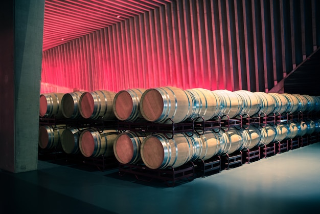 Wine barrels stored in a winery on the fermentation process