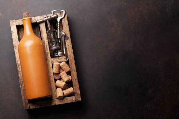 Wine bottle corkscrew and corks in wooden box Top view with space for your text