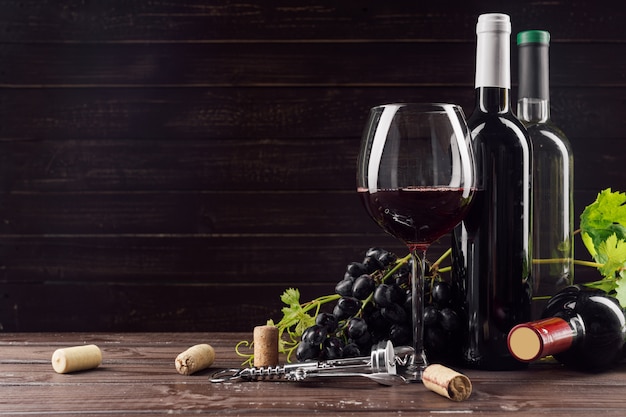 Wine bottle and grape on wooden table