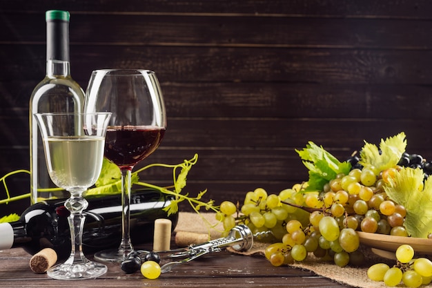 Wine bottle and grape on wooden table