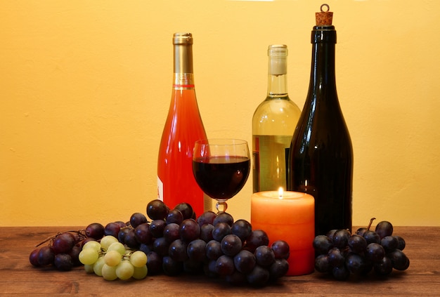 wine bottle and grapes on wood